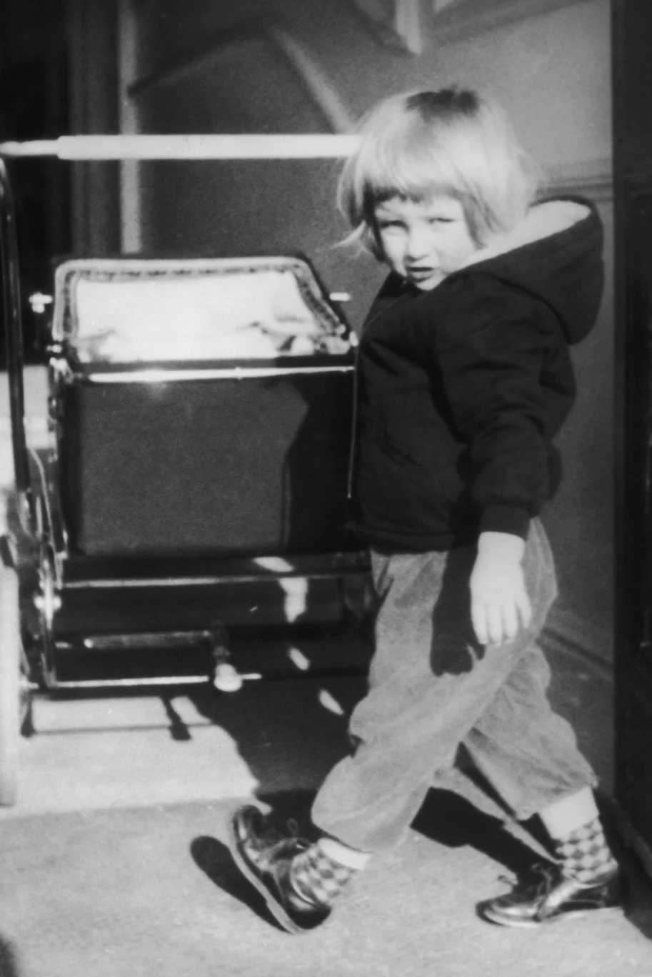 Princess Diana pushing a stroller as a child.