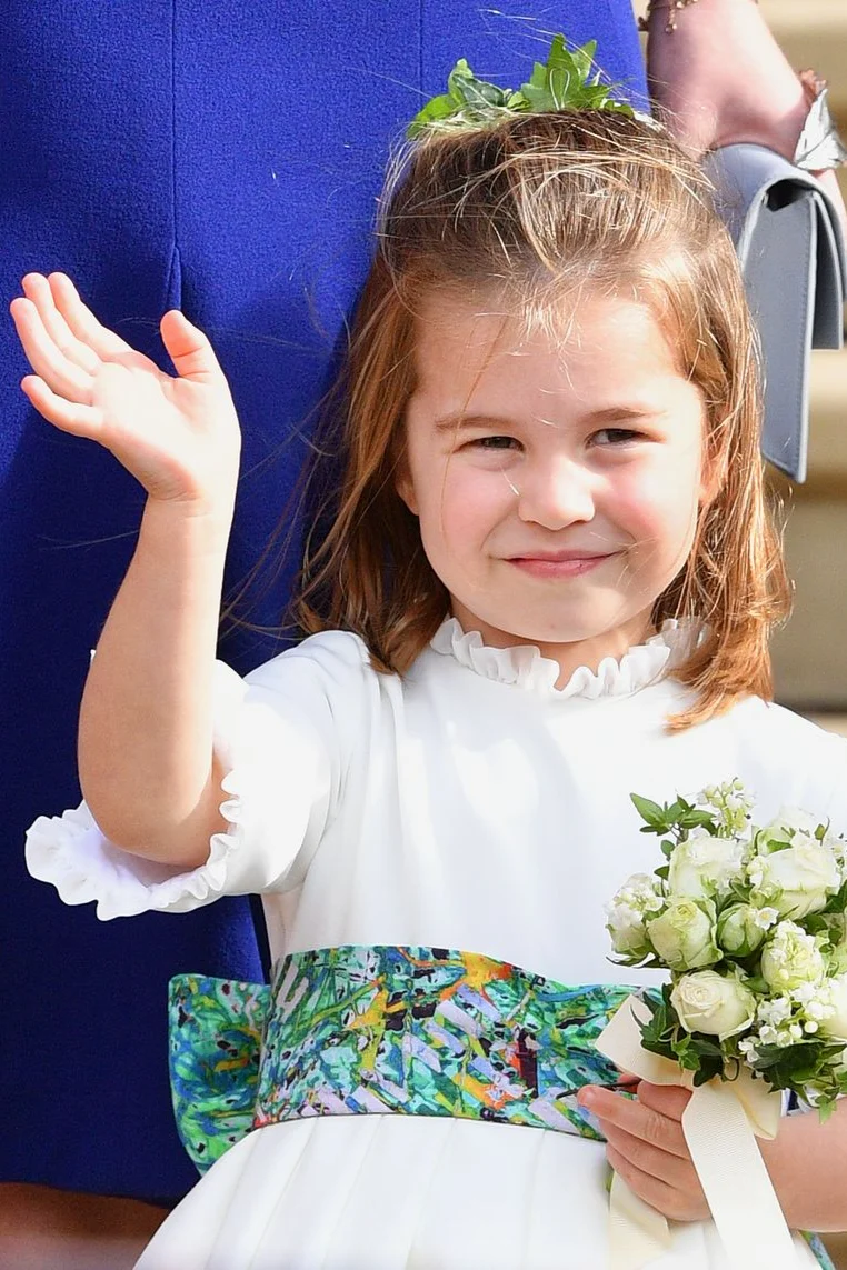 Princess Charlotte as a bridesmaid waving and holding a bouquet.