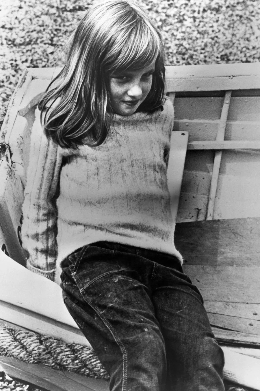 Young Princess Diana wearing a sweater and jeans.